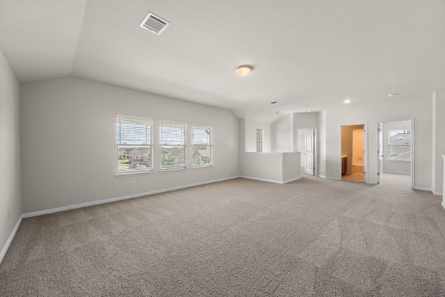 205 Falkland St, Hutto, TX 78634 - empty room with light carpet, plenty of natural light, and vaulted ceiling