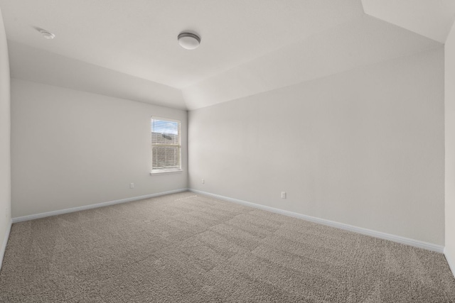 205 Falkland St, Hutto, TX 78634 - spare room featuring vaulted ceiling, carpet flooring, and a smoke detector