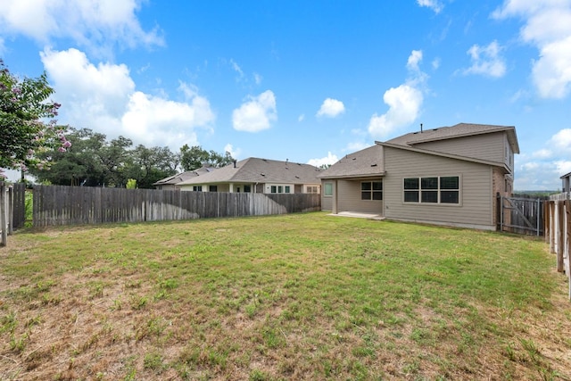205 Falkland St, Hutto, TX 78634 - fenced backyard with a patio area
