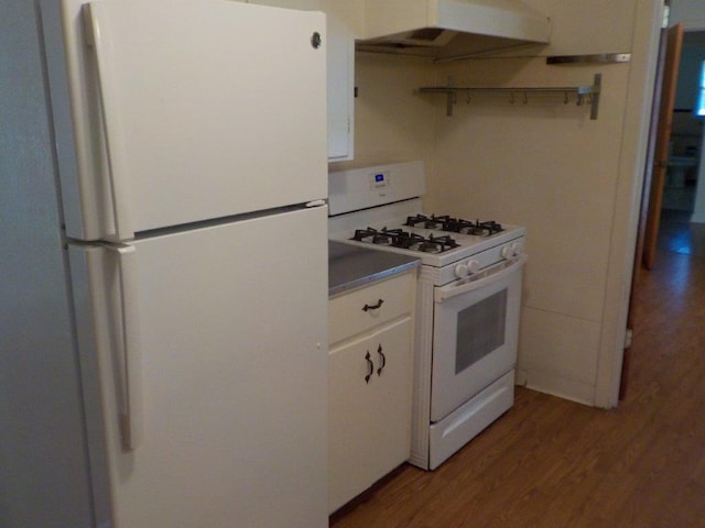 1721 E 32nd St, Austin, TX 78722 - kitchen with white appliances, exhaust hood, wood finished floors, and white cabinets