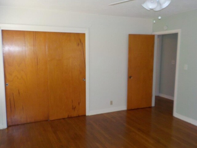 1721 E 32nd St, Austin, TX 78722 - unfurnished bedroom with a closet, wood finished floors, and a ceiling fan
