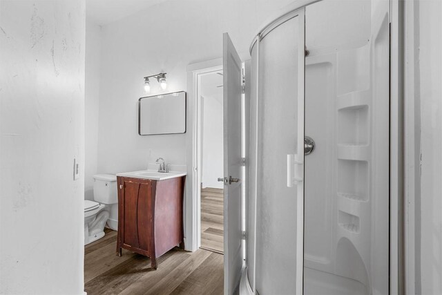 1524 E E Ave B, Temple, TX 76501 - full bathroom with a shower stall, wood finished floors, and vanity