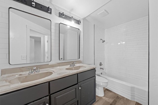 1524 E E Ave B, Temple, TX 76501 - bathroom featuring double vanity, wood finished floors, and  shower combination