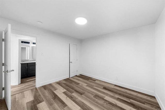 1524 E E Ave B, Temple, TX 76501 - unfurnished bedroom featuring wood finished floors and baseboards