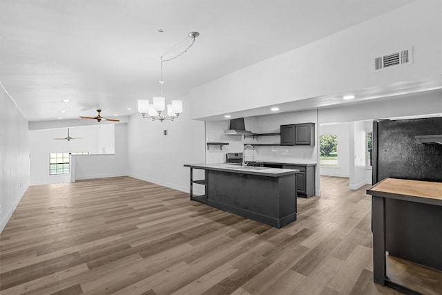 1524 E E Ave B, Temple, TX 76501 - kitchen with wall chimney range hood, open shelves, light countertops, a chandelier, and light wood-style floors