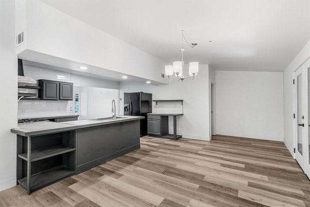 1524 E E Ave B, Temple, TX 76501 - kitchen with open shelves, black refrigerator with ice dispenser, a chandelier, light countertops, and light wood finished floors