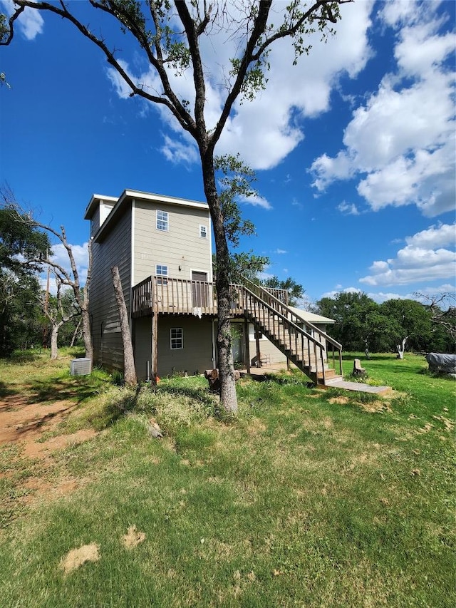 200 Nature Dr, Burnet, TX 78611 - back of property featuring stairs, a deck, and a yard