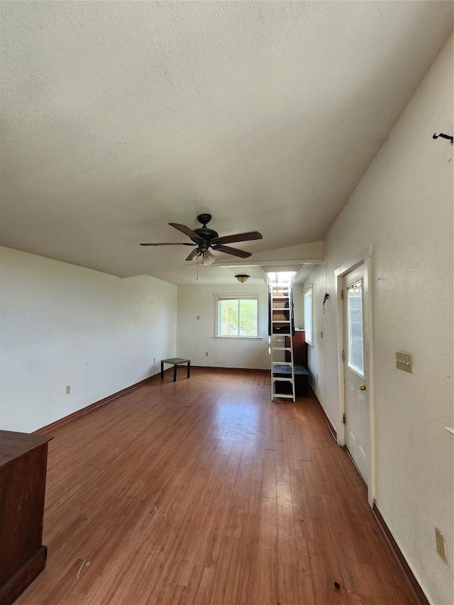200 Nature Dr, Burnet, TX 78611 - unfurnished living room featuring ceiling fan, wood finished floors, and a textured ceiling