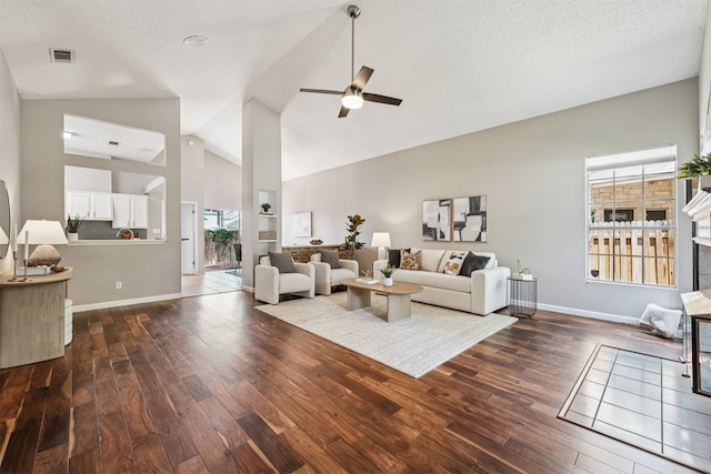 8204 Cahill Dr, Austin, TX 78729 - living room featuring dark wood-style floors, a ceiling fan, and high vaulted ceiling