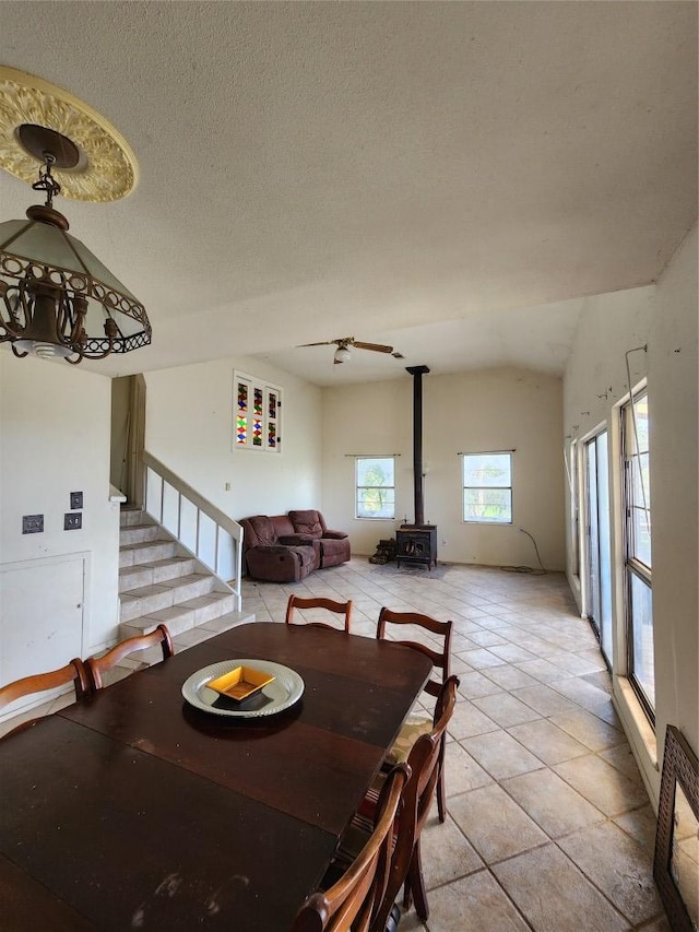 0 Monte Vista Dr, Burnet, TX 78611 - dining space featuring a wood stove, light tile patterned floors, stairs, and a textured ceiling