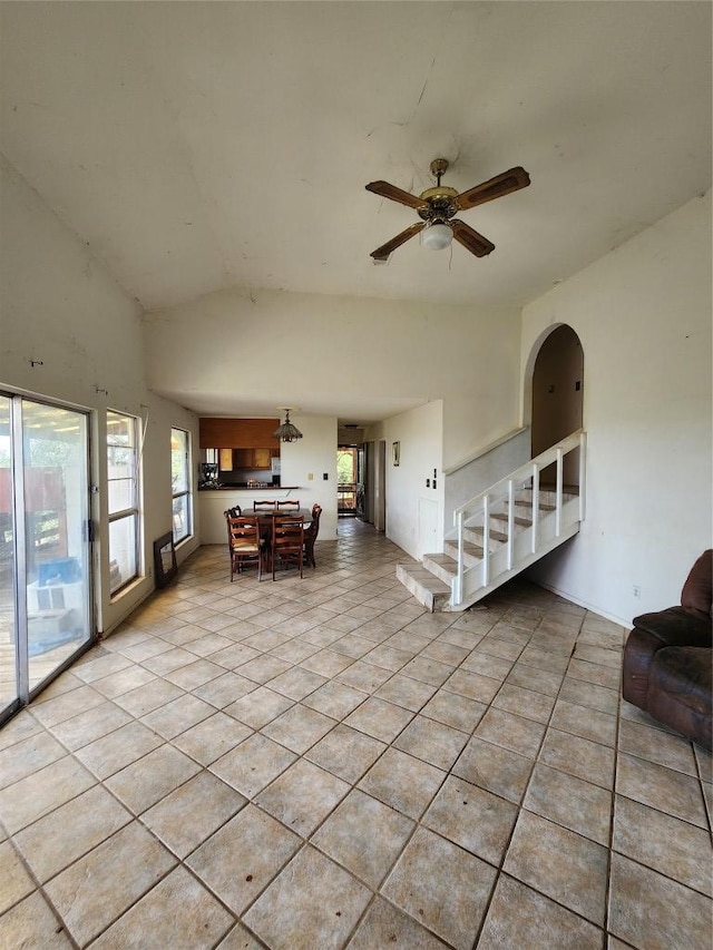 0 Monte Vista Dr, Burnet, TX 78611 - living room featuring vaulted ceiling, light tile patterned floors, ceiling fan, and arched walkways