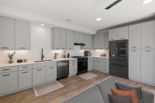 4510 Terry-O Ln Unit 139, Austin, TX 78745 - kitchen featuring fridge with ice dispenser, stainless steel dishwasher, gas stove, under cabinet range hood, and tasteful backsplash