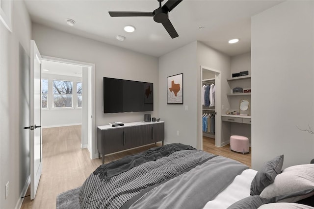 4510 Terry-O Ln Unit 139, Austin, TX 78745 - bedroom with light wood-style floors, a spacious closet, recessed lighting, and a ceiling fan
