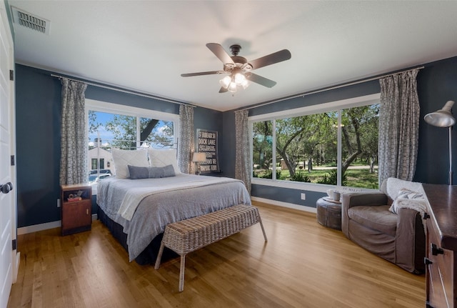 112 Louisiana Ave, New Braunfels, TX 78130 - bedroom with multiple windows, wood finished floors, and a ceiling fan
