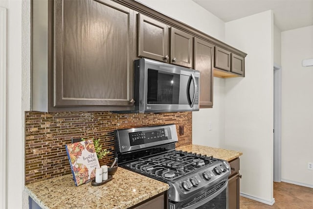 3305 Blue Ridge Dr, Round Rock, TX 78681 - kitchen featuring appliances with stainless steel finishes, tasteful backsplash, light stone countertops, and dark brown cabinetry