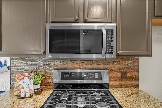 3305 Blue Ridge Dr, Round Rock, TX 78681 - kitchen view of appliances with stainless steel finishes, backsplash, and light stone countertops