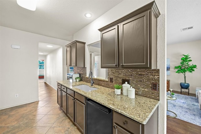 3305 Blue Ridge Dr, Round Rock, TX 78681 - kitchen featuring dishwasher, backsplash, dark brown cabinets, light stone counters, and light tile patterned flooring