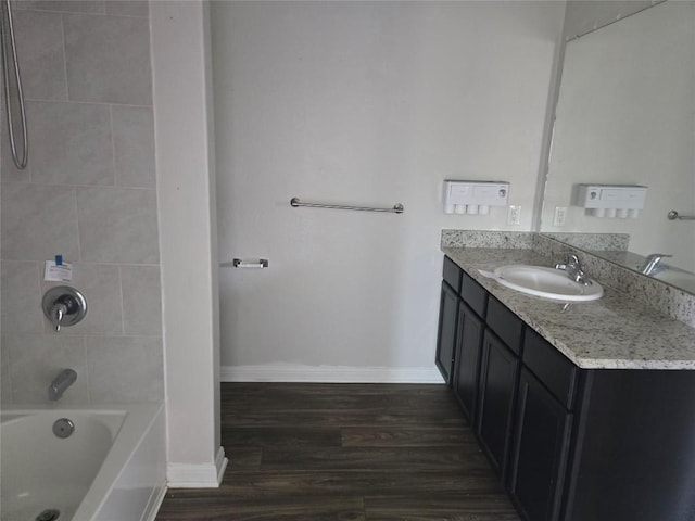 16416 Farmhouse Ln, Elgin, TX 78621 - full bathroom featuring vanity, wood finished floors, and shower / washtub combination