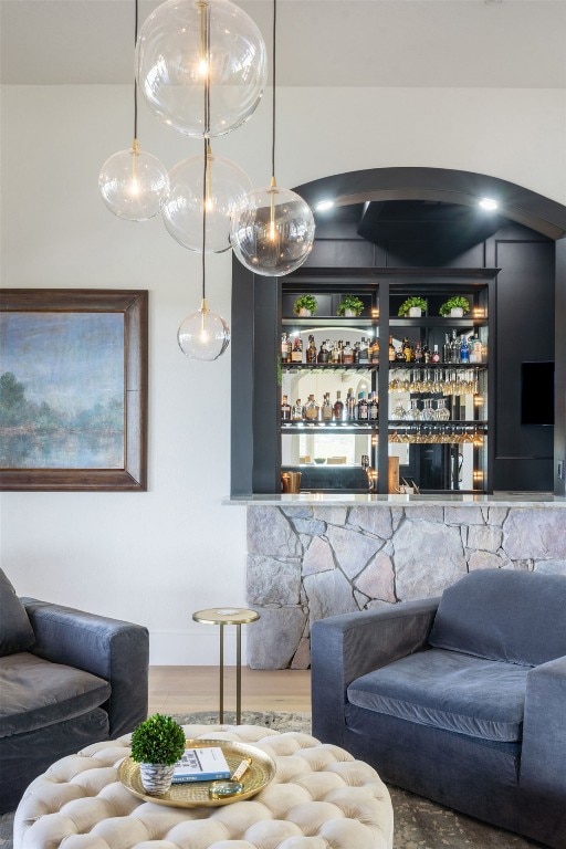 1216 Travis Bluff Way, Spicewood, TX 78669 - living room featuring a bar and wood finished floors