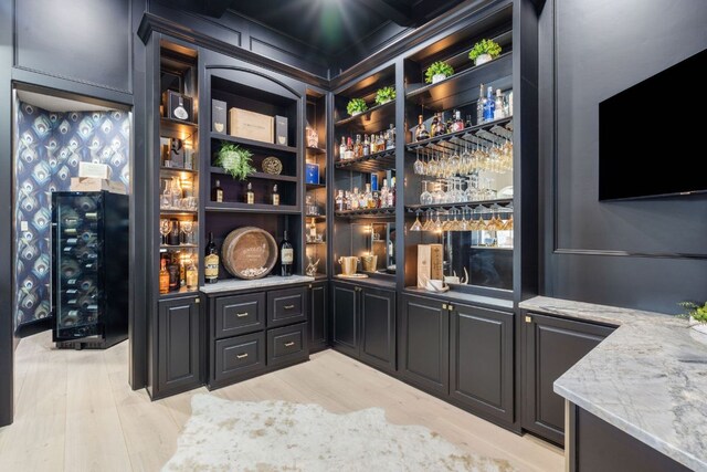 1216 Travis Bluff Way, Spicewood, TX 78669 - indoor wet bar with light wood-type flooring and wine cooler