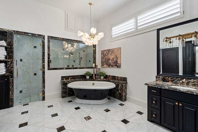 1216 Travis Bluff Way, Spicewood, TX 78669 - bathroom with a freestanding bath, a stall shower, vanity, and a chandelier