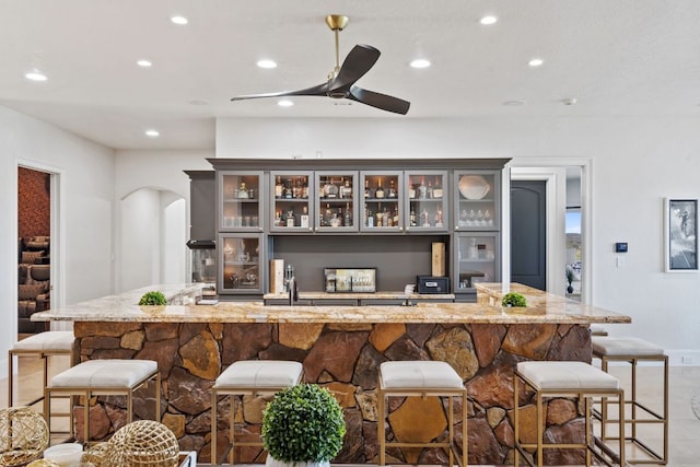 1216 Travis Bluff Way, Spicewood, TX 78669 - bar with arched walkways, recessed lighting, and a ceiling fan