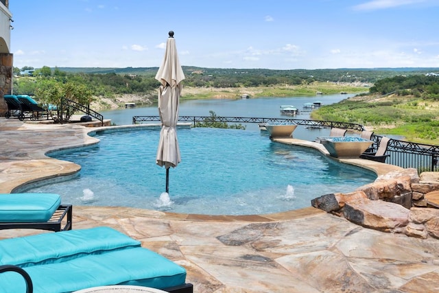 1216 Travis Bluff Way, Spicewood, TX 78669 - swimming pool featuring a patio and a water view
