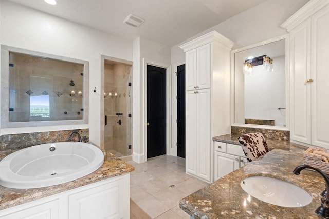 1216 Travis Bluff Way, Spicewood, TX 78669 - bathroom with a shower stall, vanity, a garden tub, and tile patterned floors