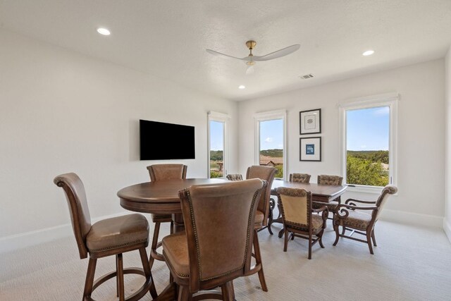 1216 Travis Bluff Way, Spicewood, TX 78669 - dining room featuring light carpet, ceiling fan, and recessed lighting
