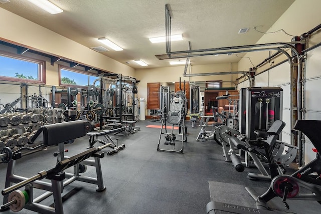 1216 Travis Bluff Way, Spicewood, TX 78669 - gym with a textured ceiling