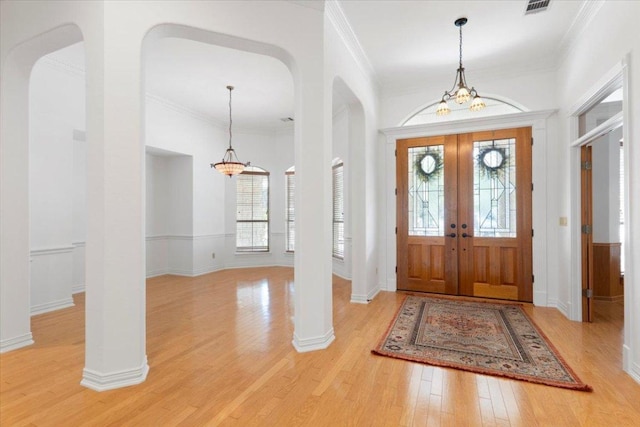 2905 Post River Rd, Cedar Park, TX 78613 - entrance foyer with a chandelier, plenty of natural light, light wood-type flooring, french doors, and ornamental molding