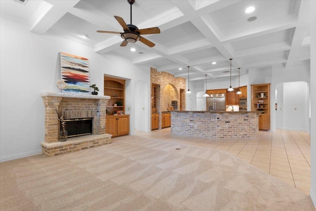 2905 Post River Rd, Cedar Park, TX 78613 - unfurnished living room with coffered ceiling, beamed ceiling, a ceiling fan, a fireplace, and built in shelves