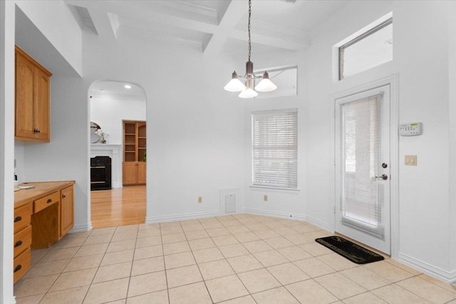 2905 Post River Rd, Cedar Park, TX 78613 - unfurnished dining area with beamed ceiling, arched walkways, coffered ceiling, a towering ceiling, and a chandelier