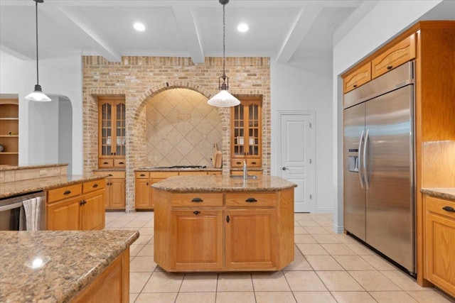 2905 Post River Rd, Cedar Park, TX 78613 - kitchen with appliances with stainless steel finishes, light stone countertops, beam ceiling, backsplash, and light tile patterned flooring