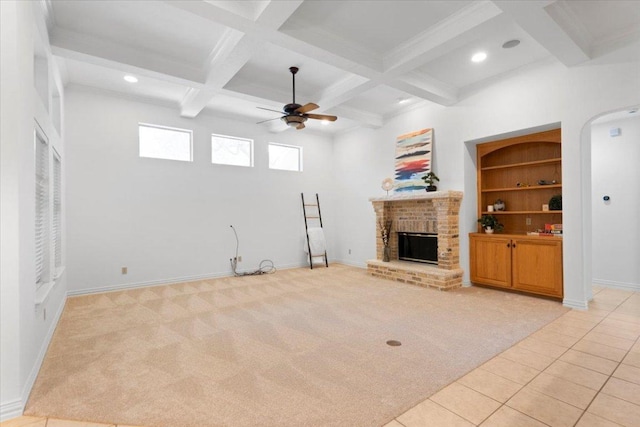 2905 Post River Rd, Cedar Park, TX 78613 - unfurnished living room featuring ceiling fan, light carpet, beamed ceiling, a brick fireplace, and coffered ceiling