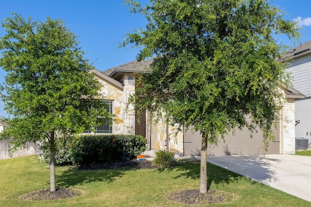 6045 Teodoro Bnd, Round Rock, TX 78665 - obstructed view of property featuring stone siding, driveway, a front yard, and a garage