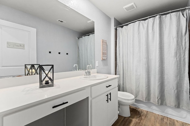 6045 Teodoro Bnd, Round Rock, TX 78665 - bathroom featuring vanity, wood finished floors, and shower / bath combo