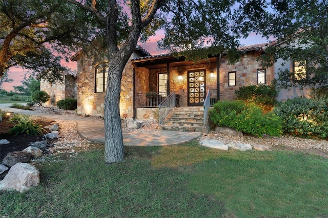 205 Hi Ridge Rd, Horseshoe Bay, TX 78657 - view of front of home featuring stone siding, a yard, and covered porch