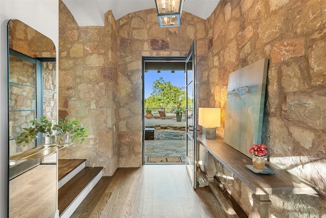 205 Hi Ridge Rd, Horseshoe Bay, TX 78657 - doorway with wood finished floors and lofted ceiling