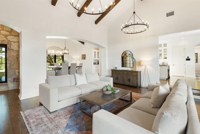 205 Hi Ridge Rd, Horseshoe Bay, TX 78657 - living room with arched walkways, a chandelier, healthy amount of natural light, high vaulted ceiling, and beamed ceiling
