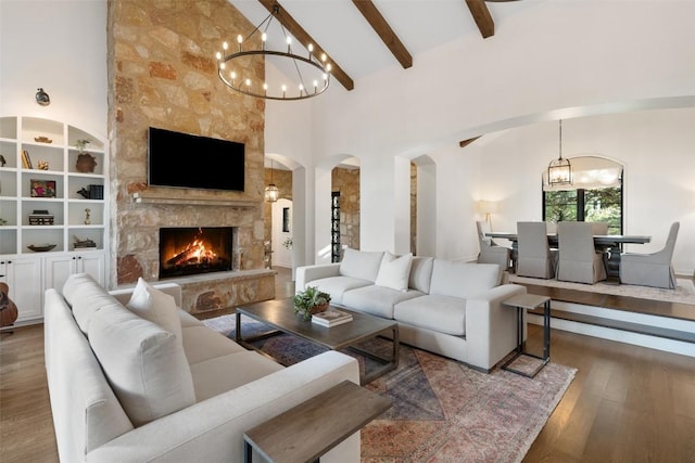 205 Hi Ridge Rd, Horseshoe Bay, TX 78657 - living room featuring arched walkways, a chandelier, wood finished floors, high vaulted ceiling, and beam ceiling