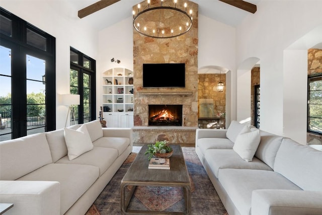 205 Hi Ridge Rd, Horseshoe Bay, TX 78657 - living area featuring high vaulted ceiling, french doors, a fireplace, arched walkways, and built in shelves