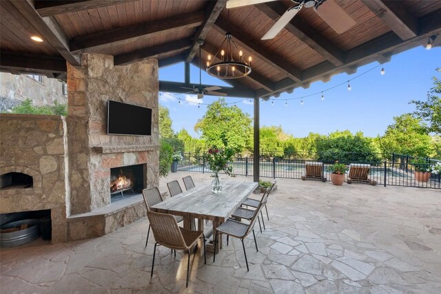 205 Hi Ridge Rd, Horseshoe Bay, TX 78657 - view of patio with an outdoor stone fireplace, ceiling fan, and outdoor dining area