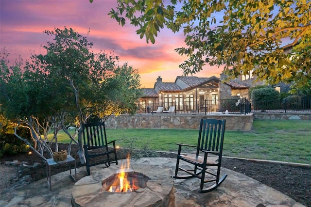 205 Hi Ridge Rd, Horseshoe Bay, TX 78657 - patio terrace at dusk featuring an outdoor fire pit and a patio area