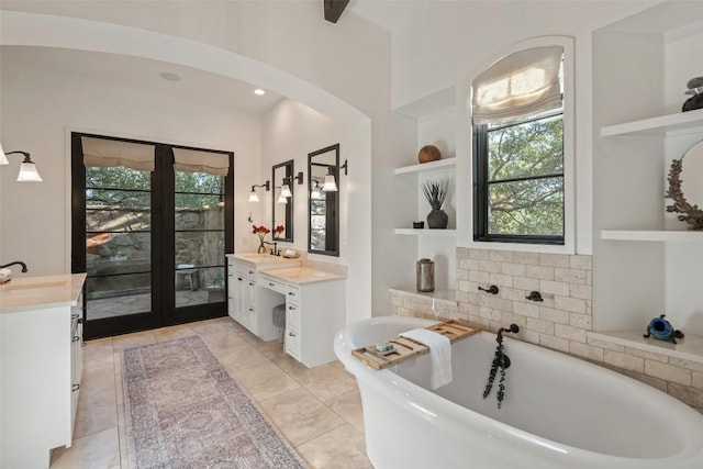 205 Hi Ridge Rd, Horseshoe Bay, TX 78657 - full bathroom with built in features, two vanities, and a freestanding bath