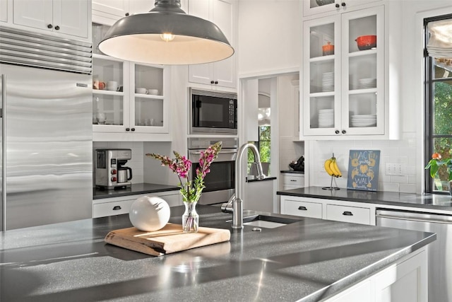 205 Hi Ridge Rd, Horseshoe Bay, TX 78657 - kitchen featuring built in appliances, white cabinetry, and backsplash