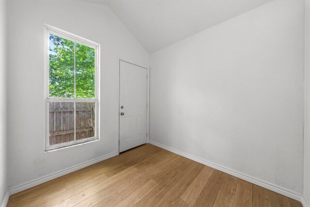 7309 Blessing Ave, Austin, TX 78752 - unfurnished room with light wood-type flooring and lofted ceiling