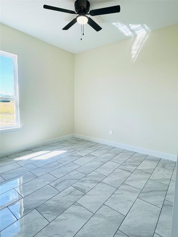 238 Twin Creeks Cir, Del Valle, TX 78617 - empty room with baseboards and a ceiling fan