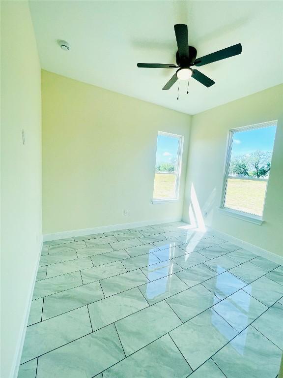 238 Twin Creeks Cir, Del Valle, TX 78617 - empty room with plenty of natural light, ceiling fan, and a smoke detector