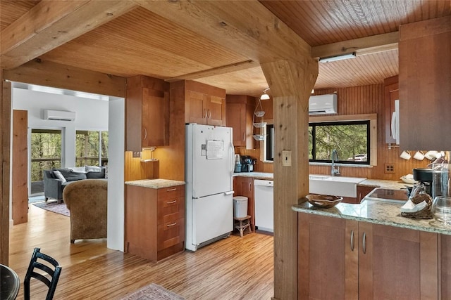 415 Balch Rd, Elgin, TX 78621 - kitchen featuring white appliances, a wooden ceiling with exposed beams, light wood-type flooring, brown cabinets, and an AC wall unit